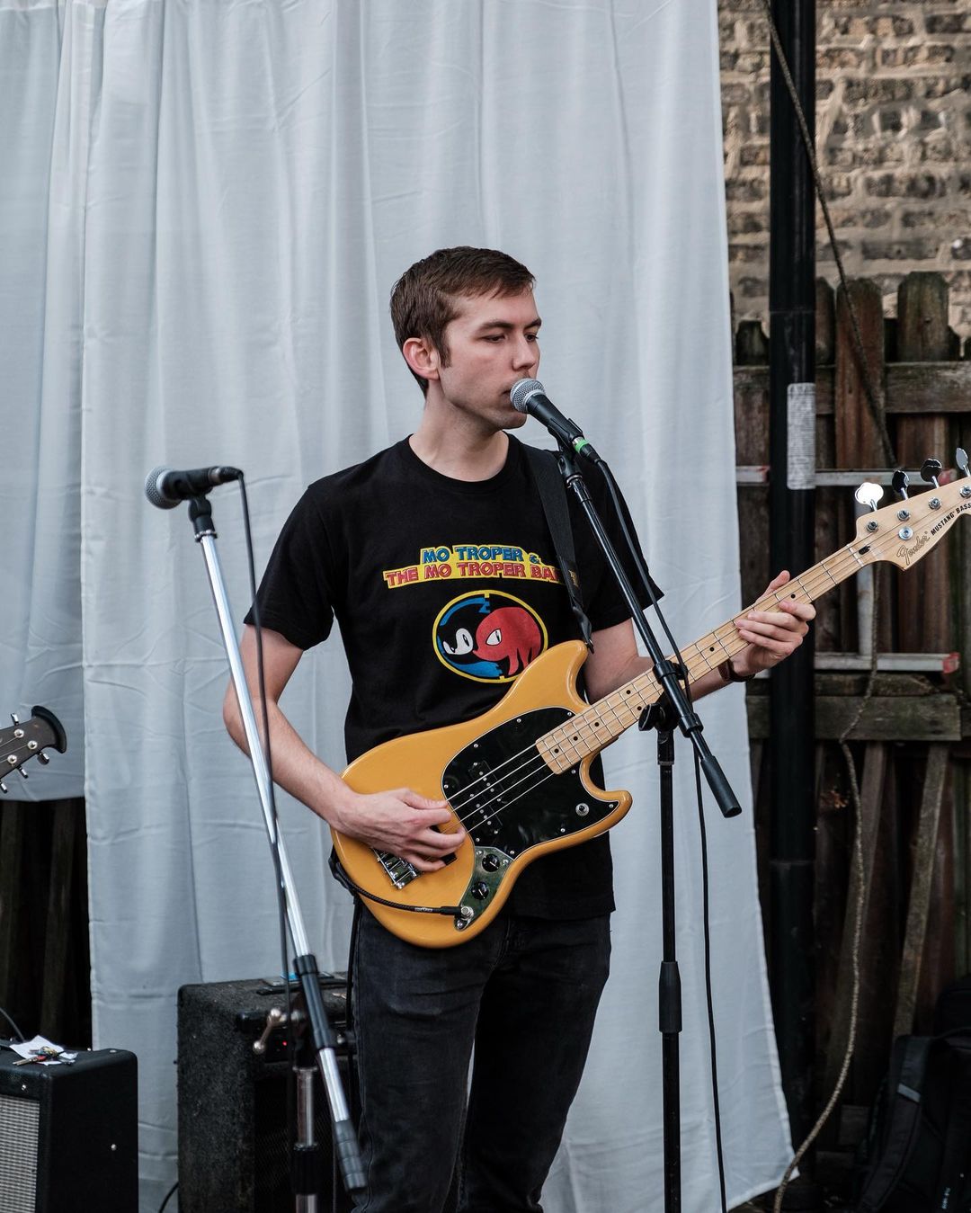 Nick Harris holding a bass guitar